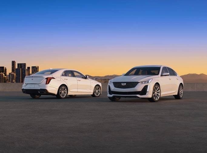 Front and Back Three-Quarters View of the 2024 Cadillac CT5 Side by Side With a Sunset in the Background