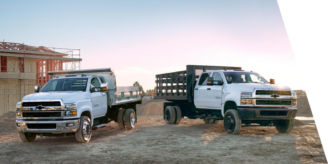  Two Chevrolet Silverado Heavy Duty Trucks Parked at a Construction Job Site