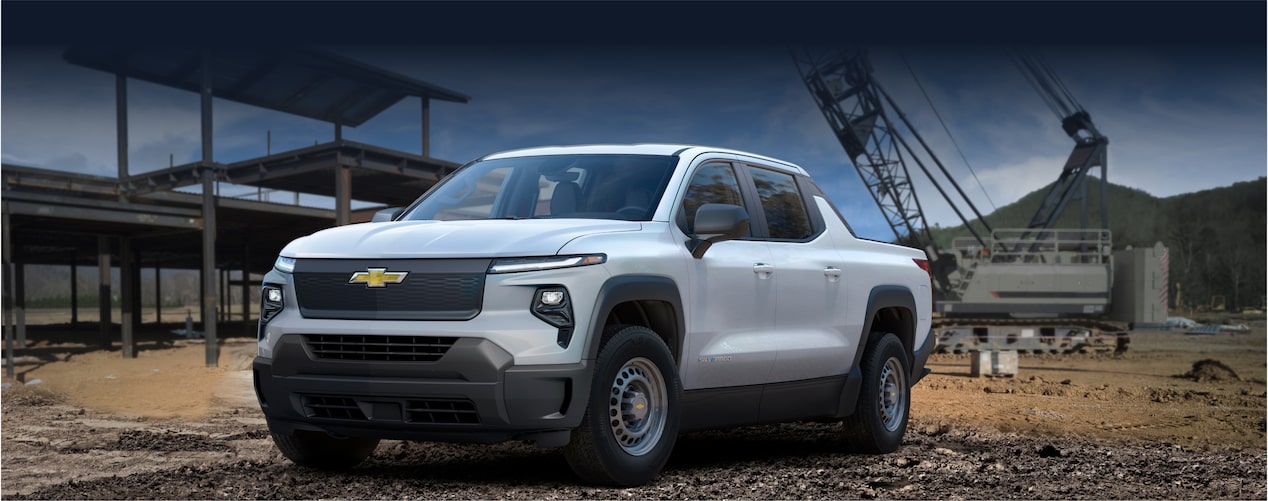 A Summit White 2024 Chevrolet Silverado EV at a Construction Site