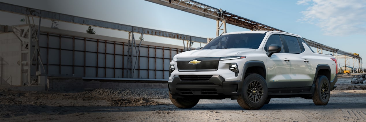 A Summit White 2024 Chevrolet Silverado EV at a Construction Site