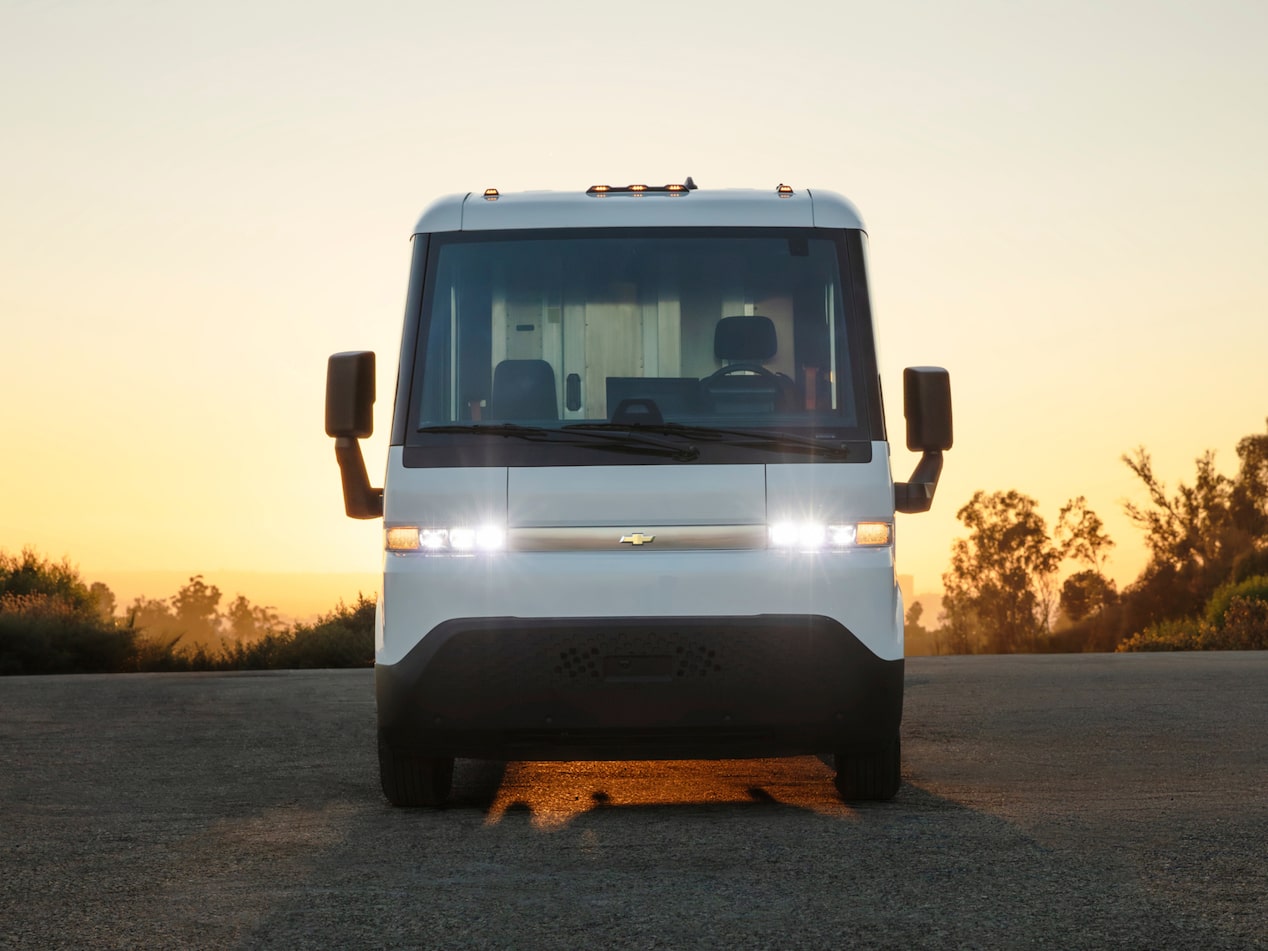A front-facing exterior shot of the 2024 Chevrolet Brightdrop with its headlights on