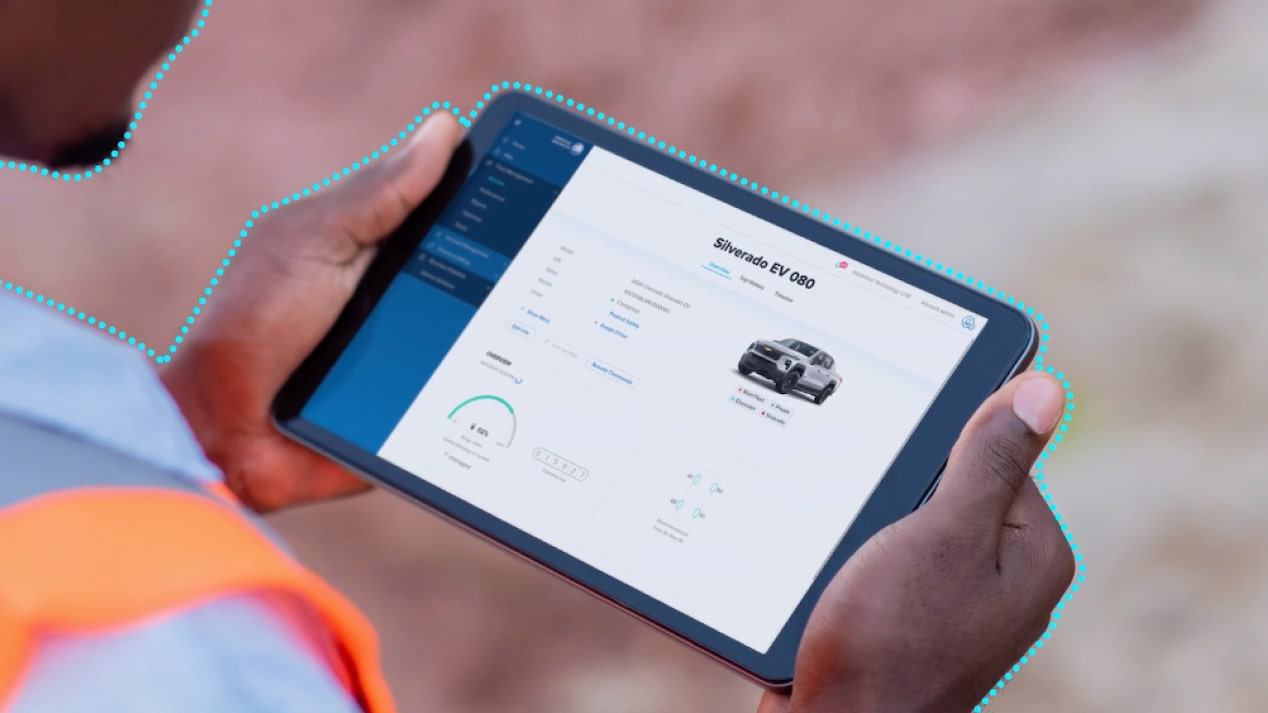 A Tablet Displaying a GM Truck Held by a Pair of Hands