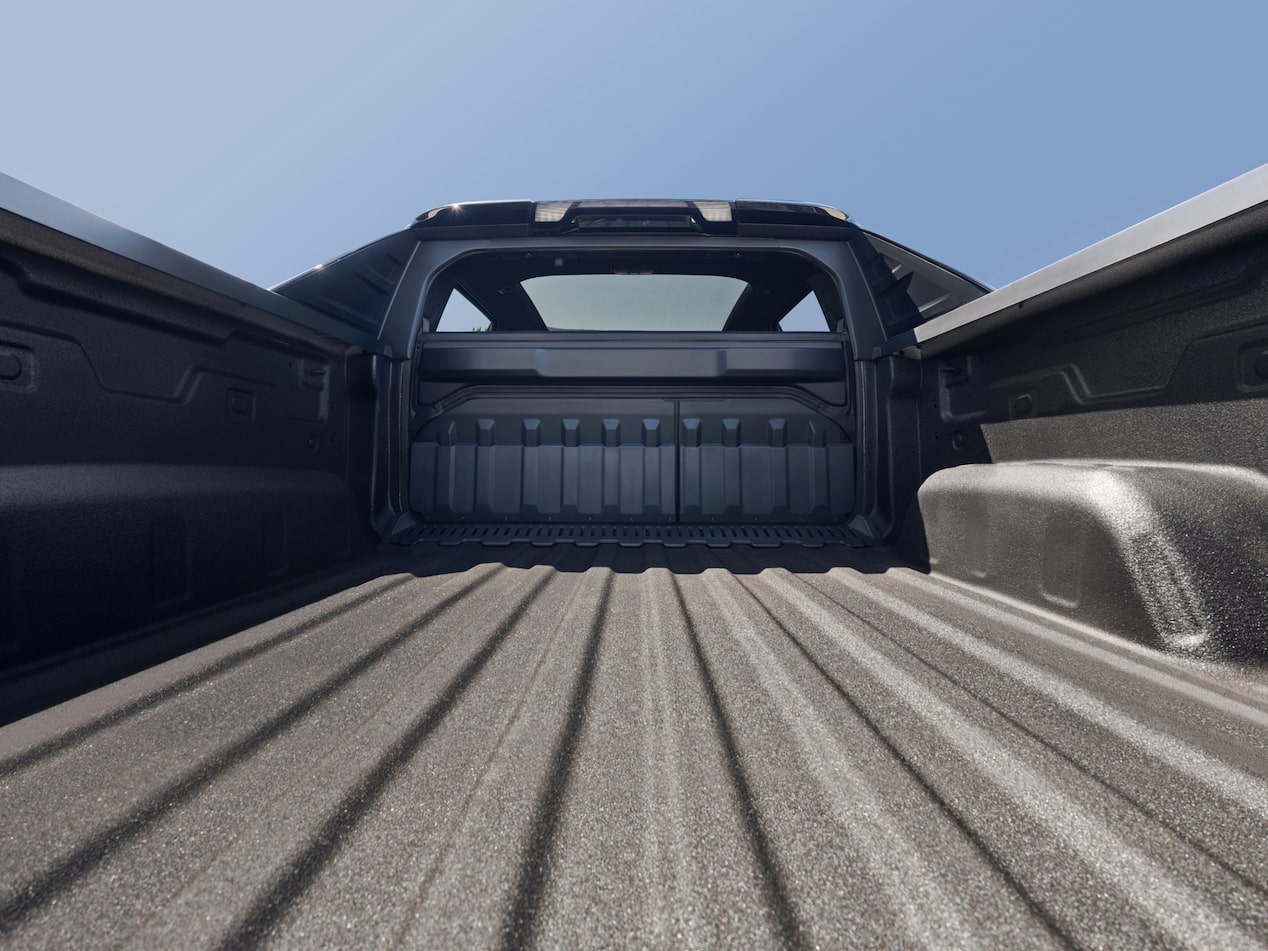 Construction Worker Loading a Toolbox Into the Bed of a Pickup Truck