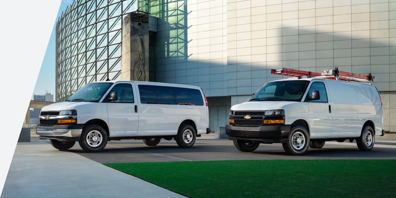 Two GM Vans parked next to each other