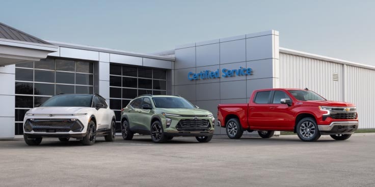 a variety of GM vehicles parked at a dealership