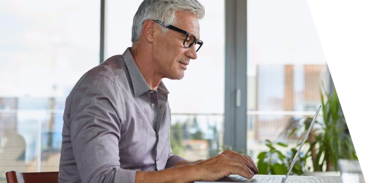 A man on his laptop reviewing GM vehicle financing plans