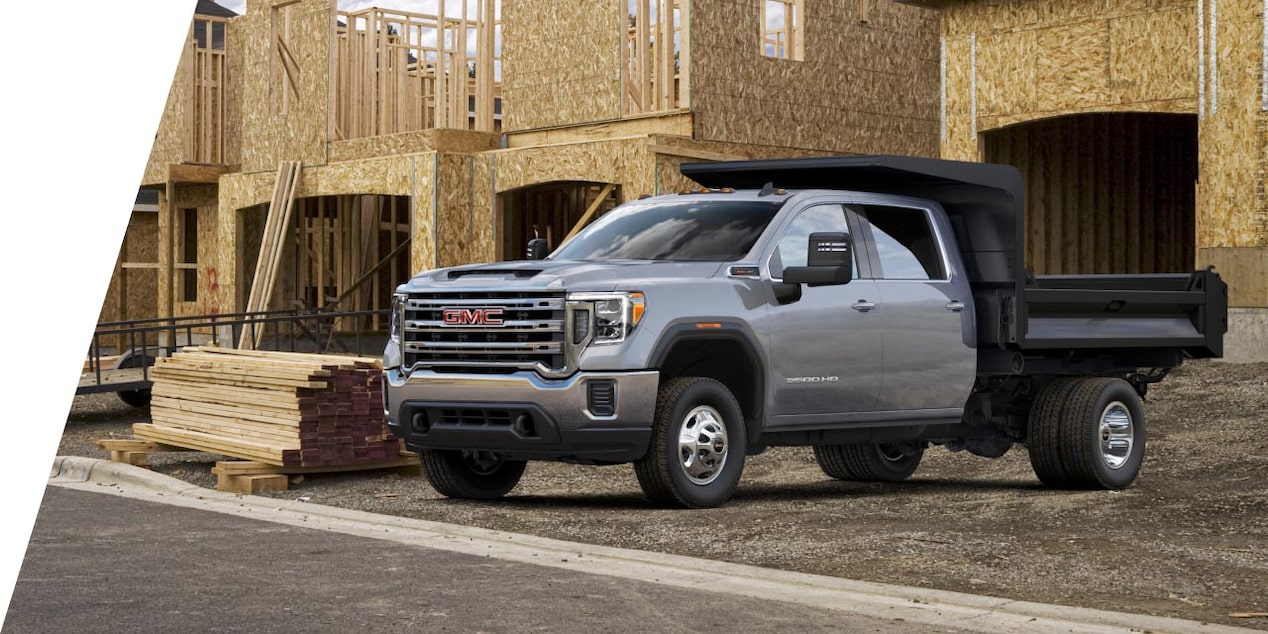 A GMC truck parked in front of a job site