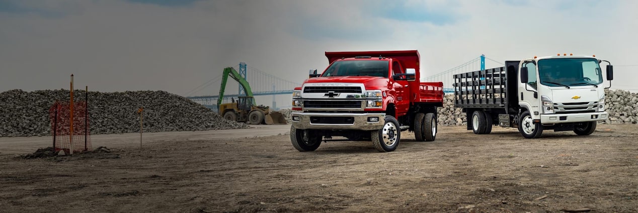 Two GM trucks on a job site