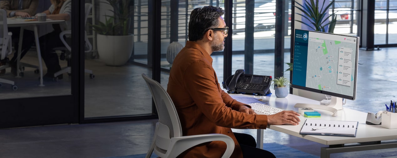 A side profile shot of a man working at a desk