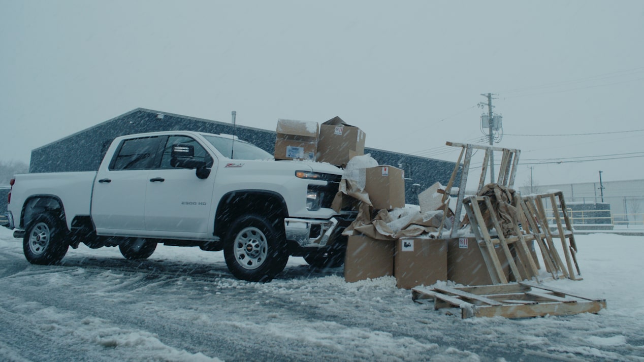 A Chevrolet Truck Parked in Front of a Pile of Boxes