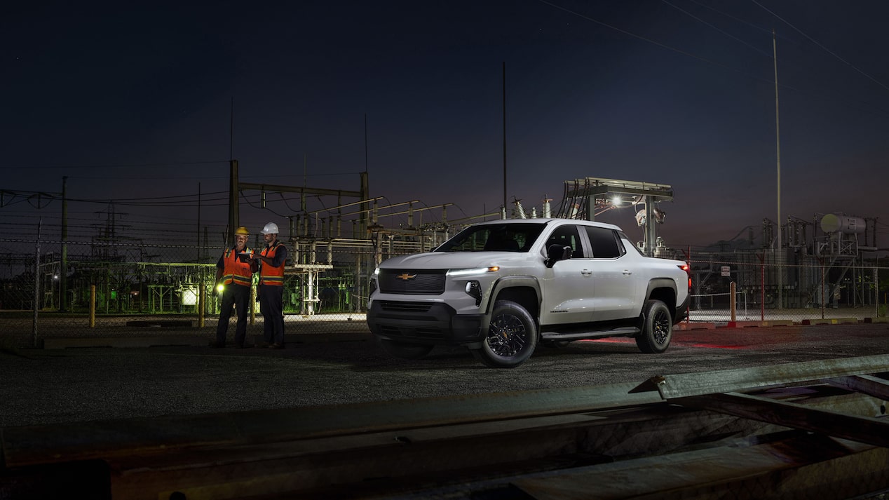 Construction workers talking near Chevrolet Silverado