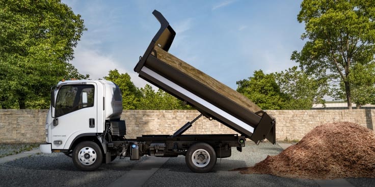  Side View of Chevrolet Low Cab Forward Truck Dumping Dirt Into a Pile