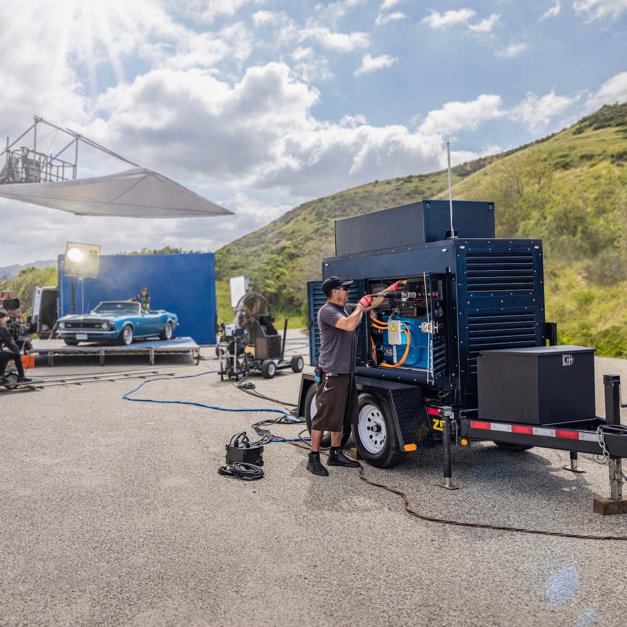 Man Fixing a Large Mobile Hydrotec Generator on Set