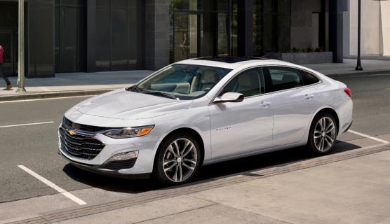 A White Chevy Malibu Parked on a City Street