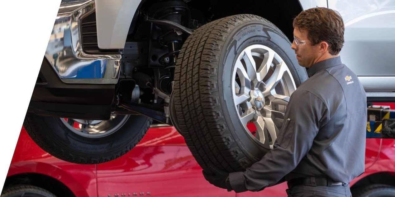  a mechanic replacing a tire on a vehicle