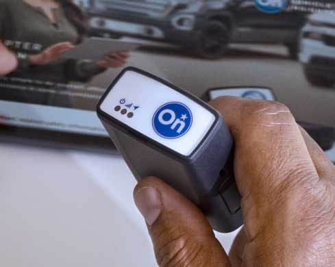 A Hand Holding the OnStar Fleet Adapter Tool