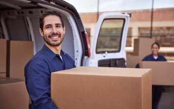 A Smiling Man Carrying a Box