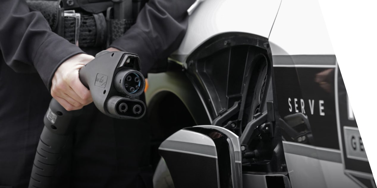 A Police Officer Plugging Charger Into the Charging Port on the 2024 Chevrolet Blazer EV PPV